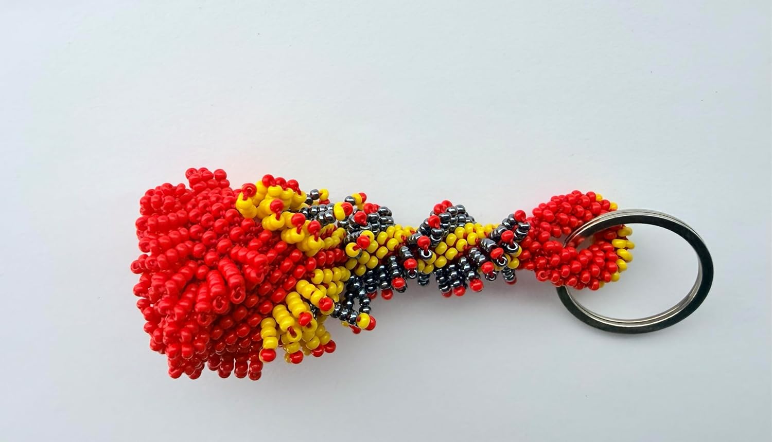 vibrant mix of red, yellow, and black glass beads woven