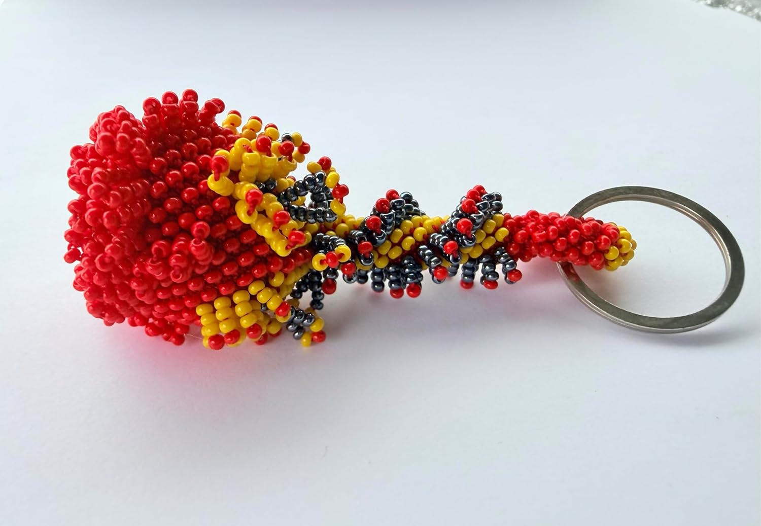 vibrant mix of red, yellow, and black glass beads woven