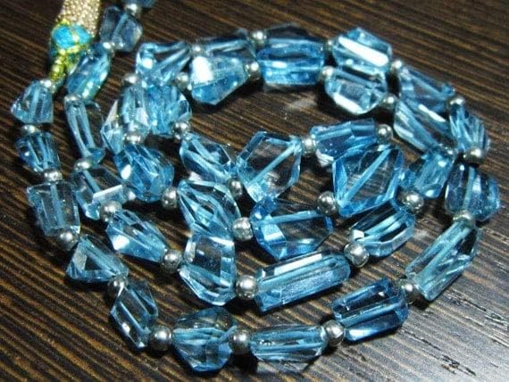 BEADS GEMSTONE 130 carat-AAA Blue Topaz Step Cut Nuggets- 19 Inch Long Strand -Stones measure- 6-10mm long. Code-HIGH-7858