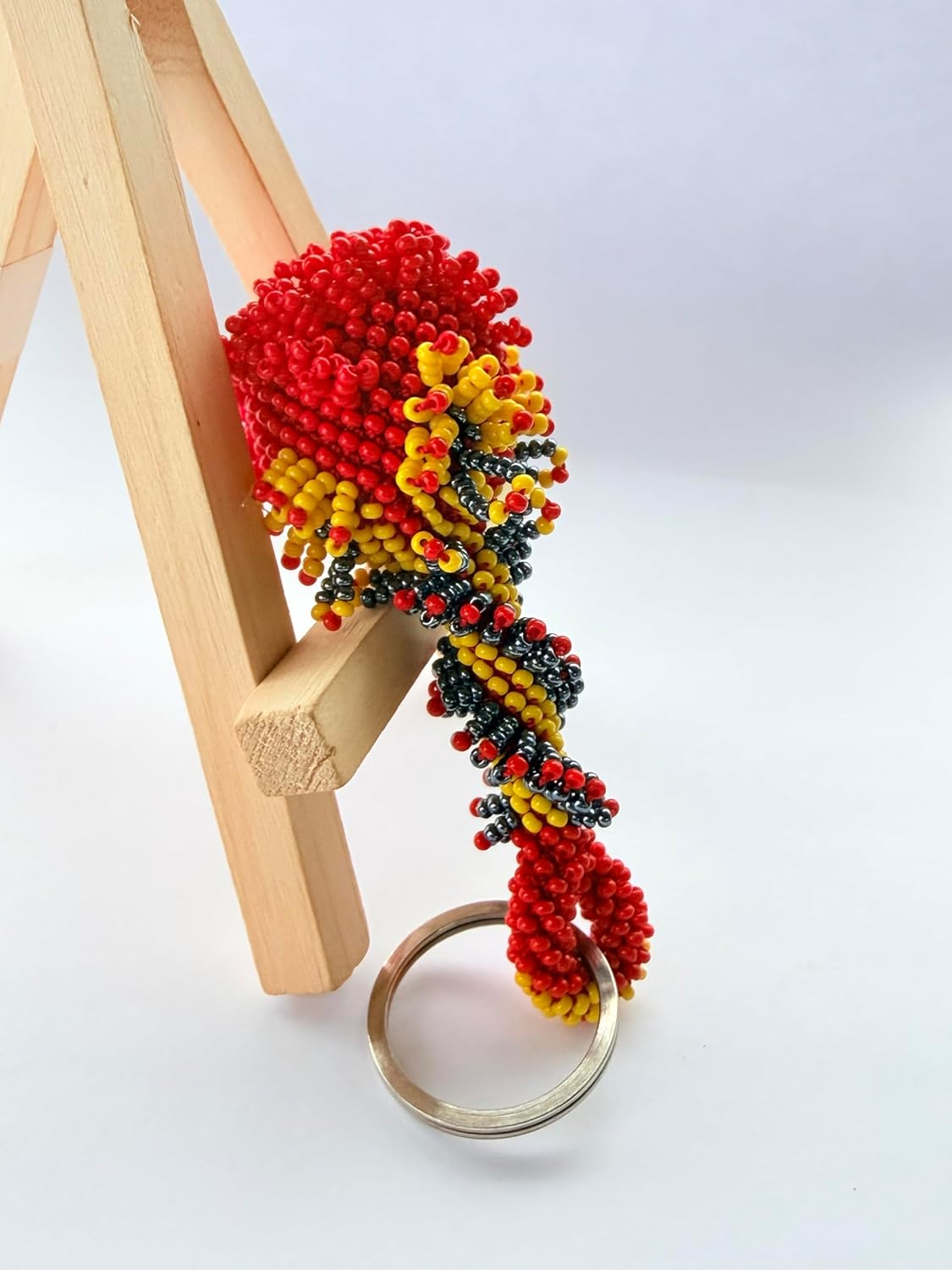 vibrant mix of red, yellow, and black glass beads woven