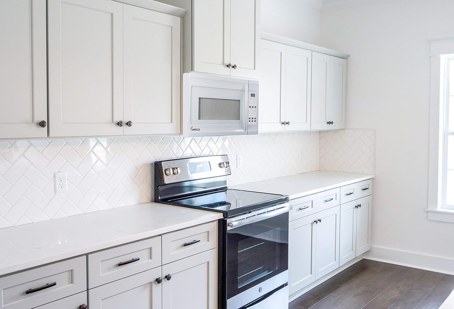 Impecca 1.6 cu. ft. Over-the-Range 30” Microwave Oven 1000 Watts, with Surface Light, 2 Speed Vent System, Touchpad Controls, Digital Clock, Timer, LED Display and Child Lock, White