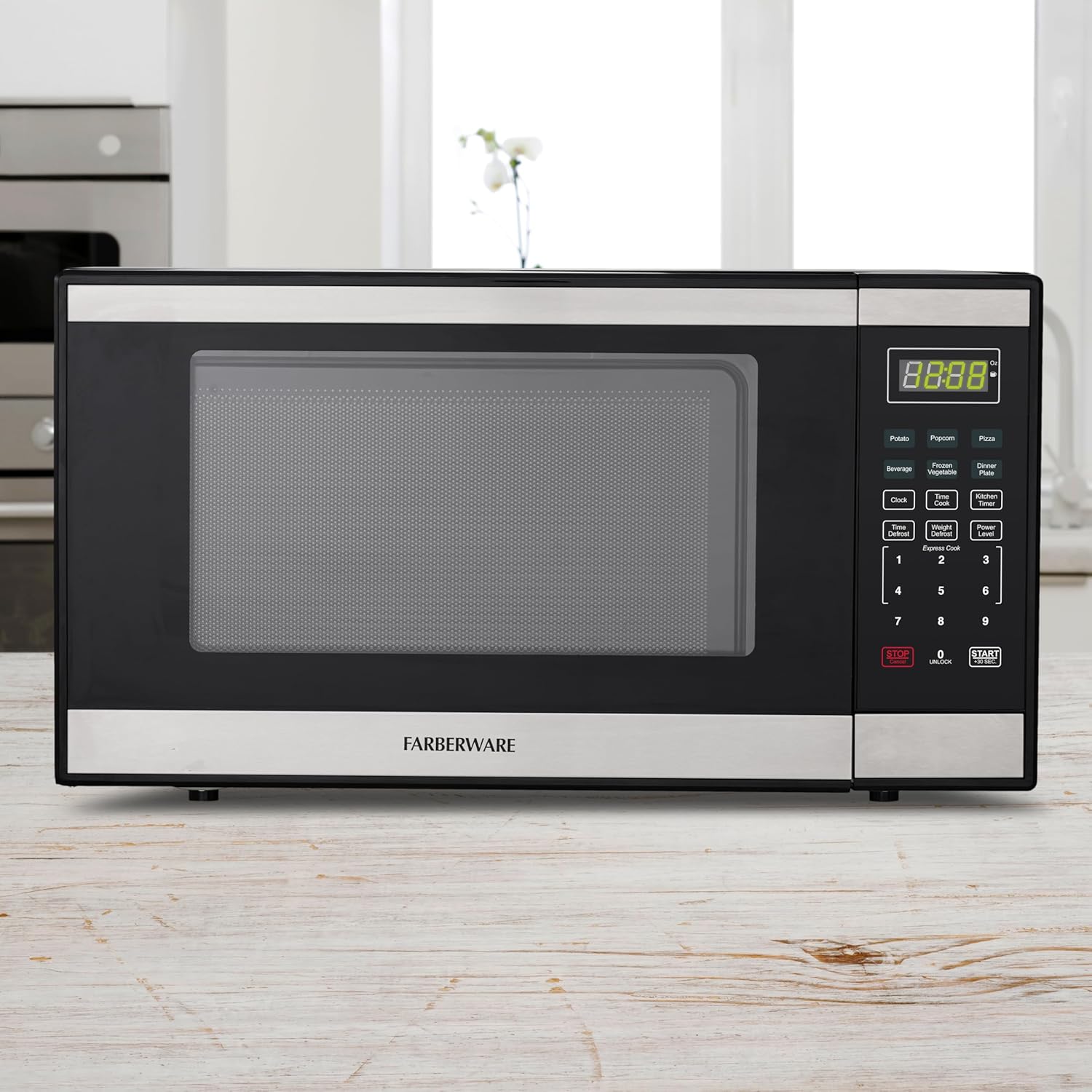 Farberware 1.1 Cu. Ft. Countertop Microwave Oven – 1000 Watts Power, Auto Cook Settings, Defrost, Easy Clean and Child Safety Lock - Stainless and Black